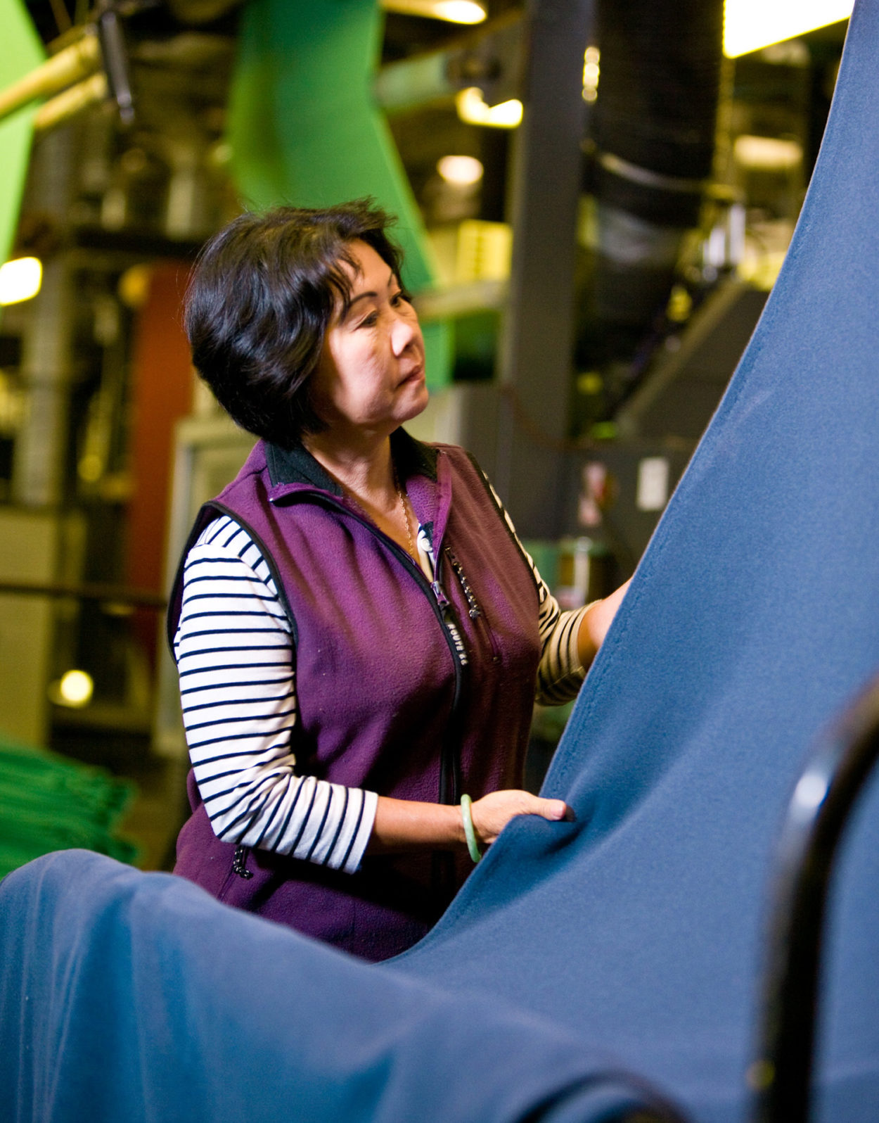 Eine Frau kontrolliert Polartec-Fleec auf Fehler. | Foto: Polartec